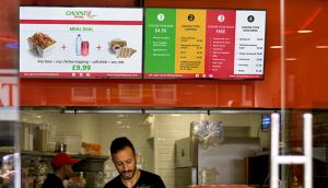Digital signage screens displaying System on Chip menu boards at Chopstix restaurant in London