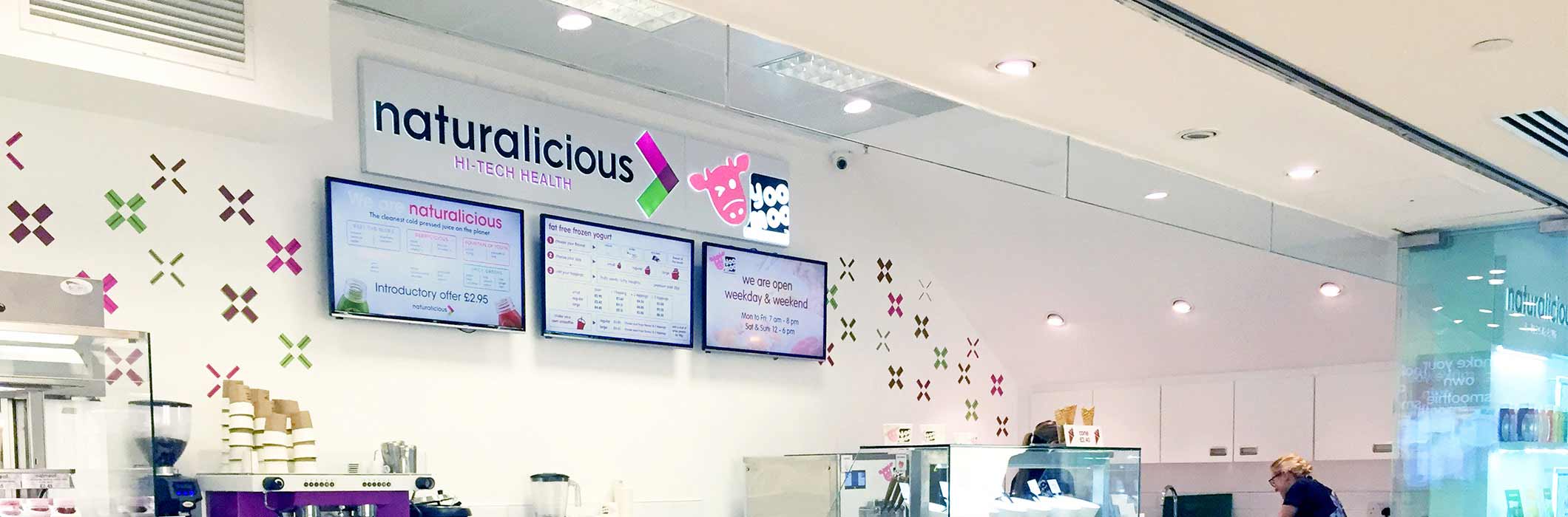 Menu board digital signage screens at Naturalicious Hi-Tech health by Yoo Moo, a restaurant in Canary Wharf London